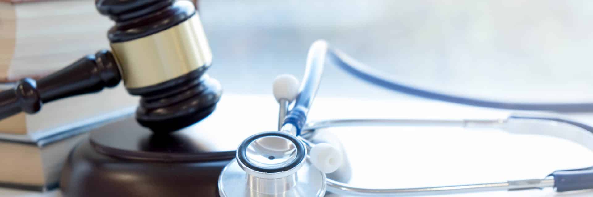 Gavel and stethoscope. medical jurisprudence. legal definition of medical malpractice. attorney. common errors doctors, nurses and hospitals make medical negligence laws in dubai